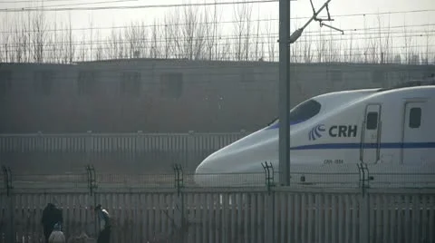 White high-speed train between the wire,People in railway side. Stock Footage