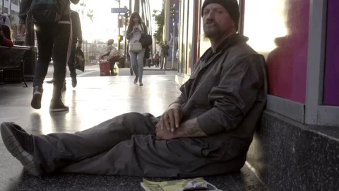 White homeless man looking at camera smoking cigarette or joint on street LA 스톡 동영상 70478855