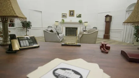 White house tilt down to documents on oval office desk Stock Footage 72980494