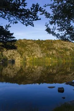 White house on top of hill with reflection in the water Stock Photos