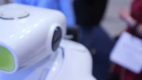 White humanoid robot in foreground at public exhibition Vídeo Stock 344989554