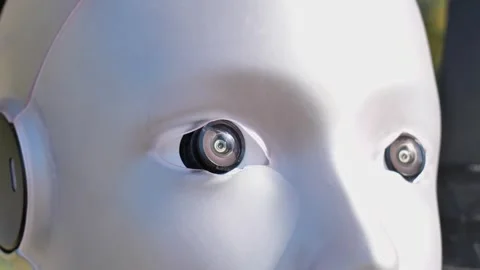 White humanoid robot head with camera lens eyes, glossy plastic android face 스톡 동영상 347274668