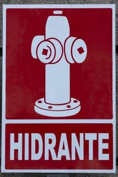 White hydrant sign on a red background. Stock Photos