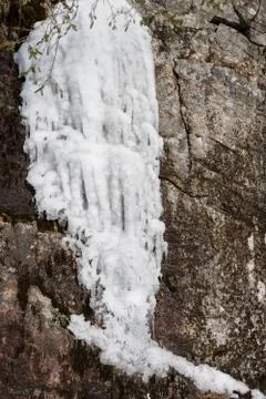 White icicles coming down from a mountain, vertical image Stock Photos