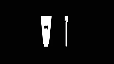 White icon of toothpaste and brush appears on a black background. Stock Footage 219742096