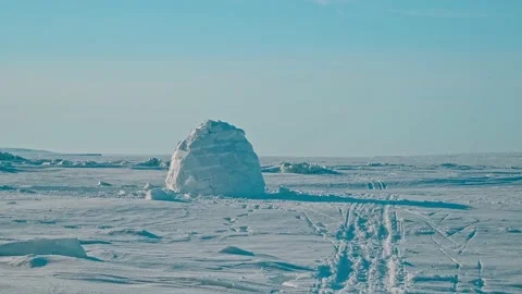White igloo with snow blocks located among endless snowfield Stock Footage 131463566