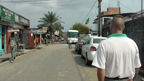 White immigrant walking by a flag Stock Footage 80847402