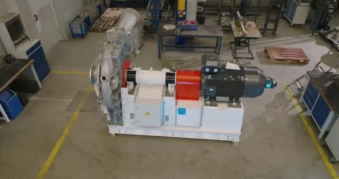 White Industrial Machine with Red Coupling, Motor Drive, Elevated Wide Shot Stock Footage 340357349