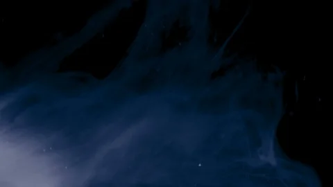 White ink and particles slowly floating like Stock Footage 100533092