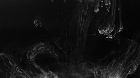 White ink and smoke floating in space on black background Stock Footage 58329779