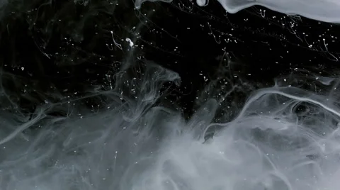 White ink on black background floating slowly trough space, close up Видео 53240442