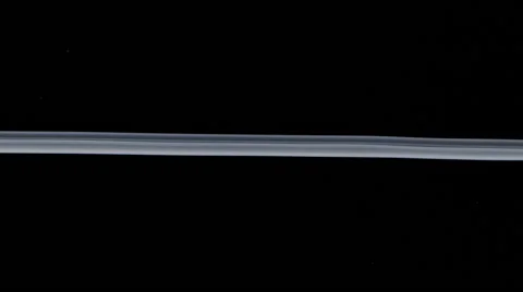 White ink thread floating in water like smoke on black background Stock Footage 57854560