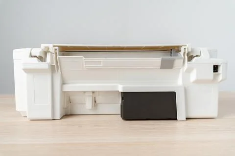 White Inkjet Printer With Visible Ink Cartridge on Wooden Desk in Office Te.. Stock Photos