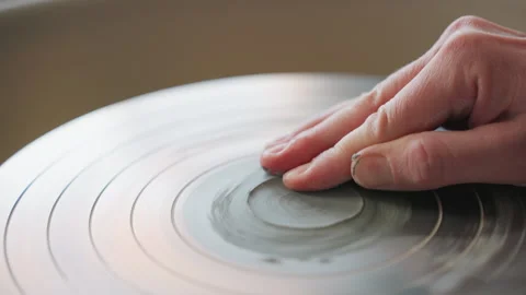 White instructor demonstrating centering and polishing techniques. Careful hand Stock Footage 337362816