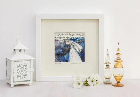 White interior display. Framed hare collage drawing, blue background. 写真素材