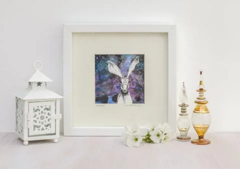 White interior display. Framed hare collaged drawing, blue background. Foto stock