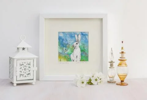 White interior display. Framed rabbit collaged drawing, bright background. Foto stock