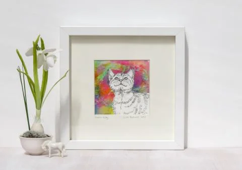 White interior display. Framed smiling cat painting, colourful background. Foto stock