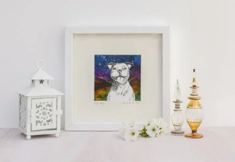 White interior display. Framed smiling Staffy dog collaged drawing. Stock-Fotos
