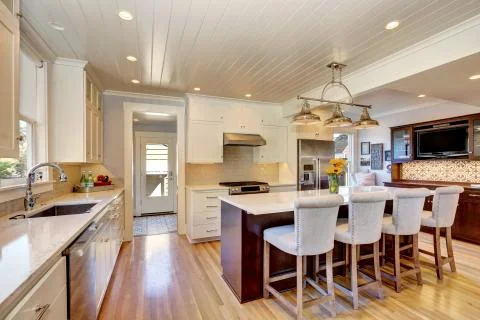 White interior of kitchen room with large bar style kitchen island and stools Stock Photos