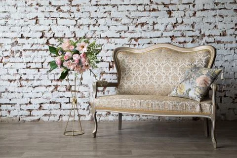 White interior of studio with white and pink flowers. Stock Photos
