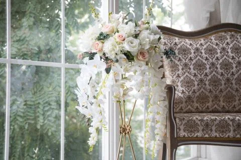 White interior of studio with white and pink flowers. Stock Photos