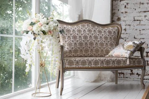 White interior of studio with white and pink flowers. Stock Photos