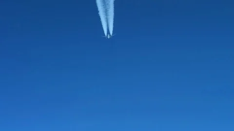White inversion trace airplane on a clear blue sky. Stock Footage 100591691