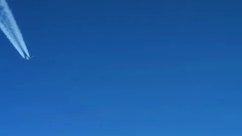 White inversion trace airplane on a clear blue sky. Stock Footage 100592174