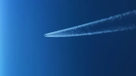 White inversion trace airplane on a clear blue sky. Stock Footage 100626857