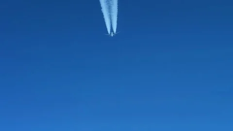 White inversion trace airplane on a clear blue sky. Stock Footage 100627107