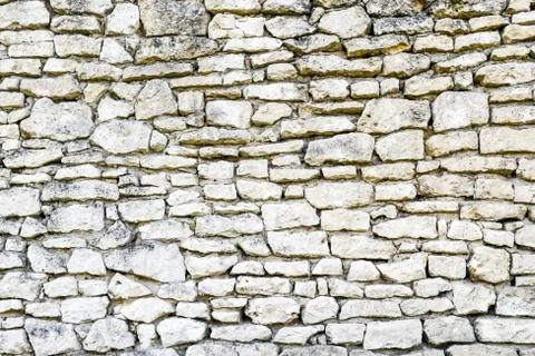 White irregular brick wall texture or background. Stock Photos