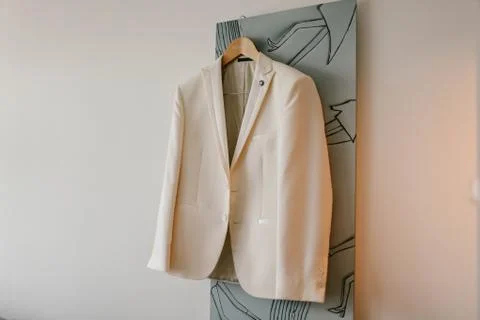 White jacket hanging on a hanger Stock Photos