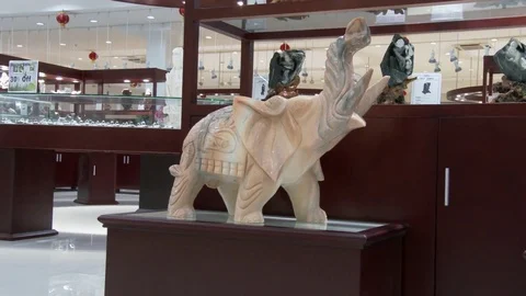 A white jade elephant in an upscale jade store in China, 4K. Stock Footage 79703310