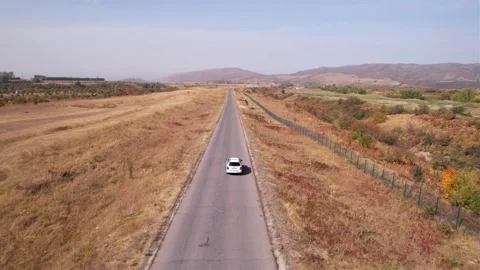 A white jeep is driving on the road. Video stock 168218133