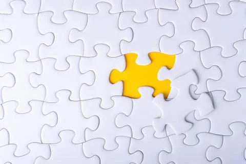 White jigsaw puzzle and missing pieces with selective focus and crop fragment 库存照片