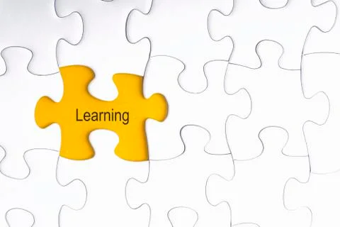 White jigsaw puzzle and missing pieces with words LEARNING  写真素材
