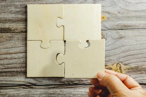 White jigsaw puzzle connecting together. Team business success partnership or Stock Photos