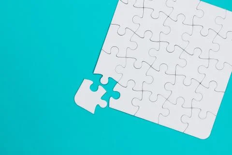 White jigsaw puzzle with a missing piece - blue background 写真素材