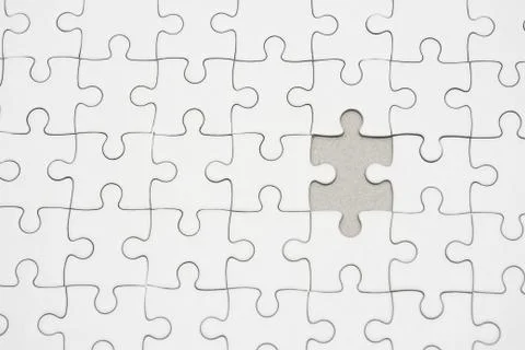 White jigsaw puzzle pattern background. placing last piece of jigsaw puzzle Stock Photos