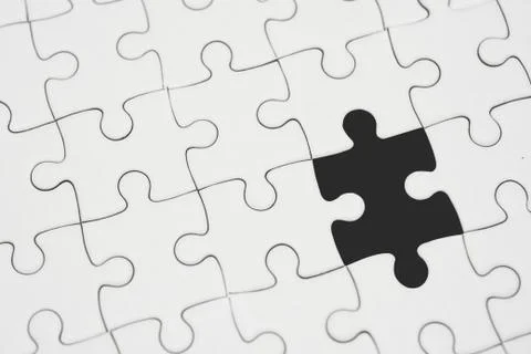 White jigsaw puzzle pattern background. placing last piece of jigsaw puzzle Stock Photos