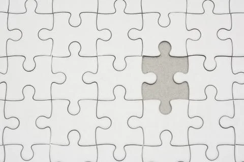 White jigsaw puzzle pattern background. placing last piece of jigsaw puzzle Stock Photos