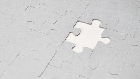 White jigsaw puzzle pattern background. placing last piece of jigsaw puzzle Foto stock