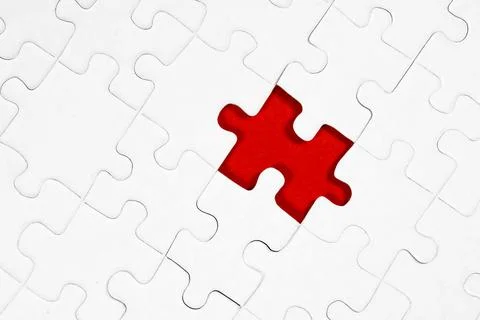 White jigsaw puzzle pattern background. placing last piece of jigsaw puzzle. Foto stock