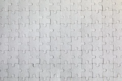 White jigsaw puzzle. White puzzle pieces on color background. Unfinished wh.. 库存照片