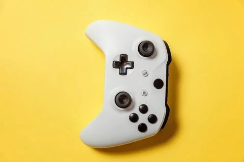 White joystick on yellow background. Computer gaming competition videogame co Stock Photos