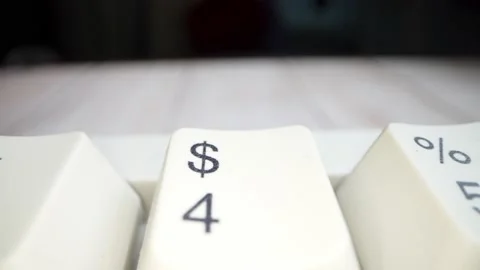 White keyboard dollar sign. Camera movement from left to right. Macro footage. Stock Footage 146107005