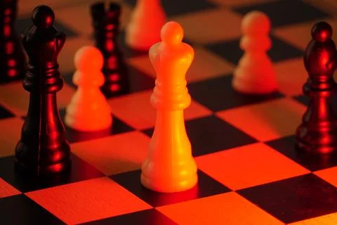 The white king glows under intense red lighting, creating a dramatic atmosphere  Stock Photos