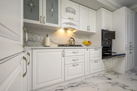 White kitchen in classic style, front view Stock Photos
