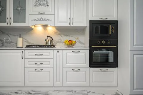White kitchen in classic style, front view Stock Photos